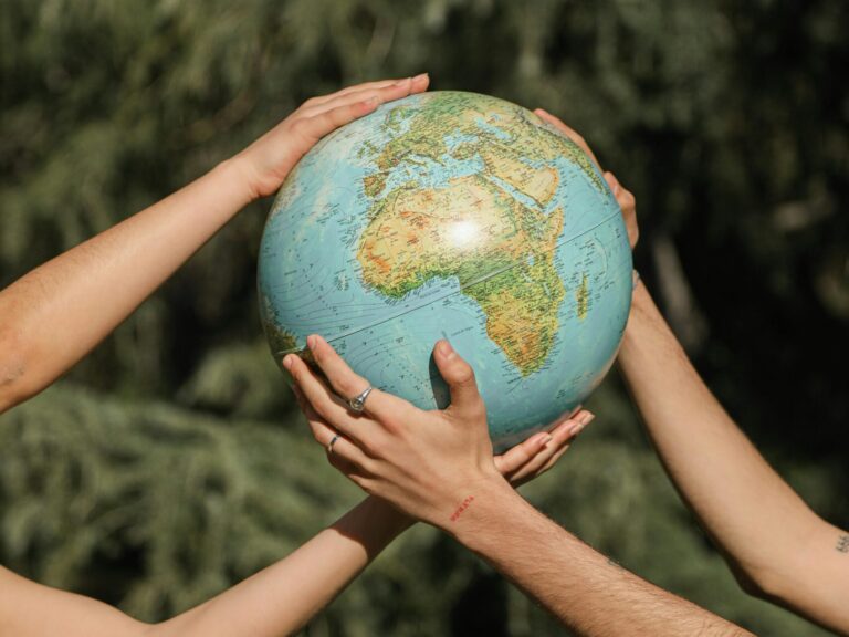 A couple holding a globe, representing ESG principles for a green living.