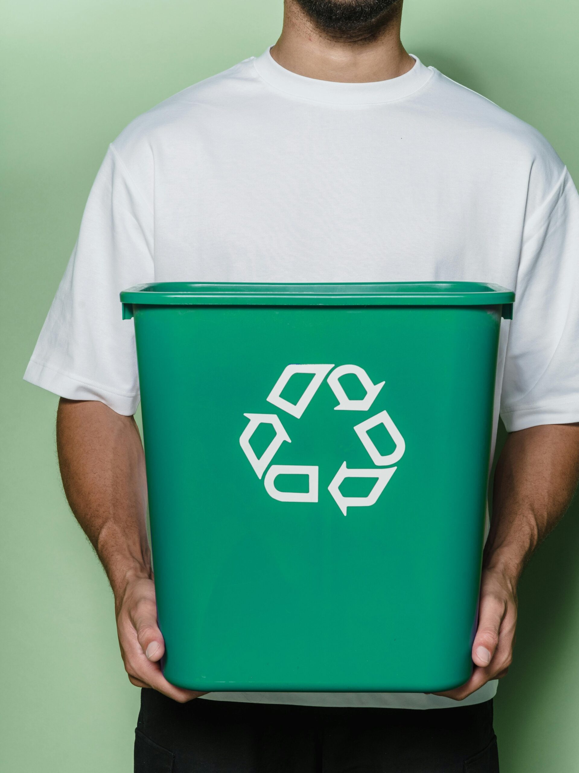 A man holding recycle bin.